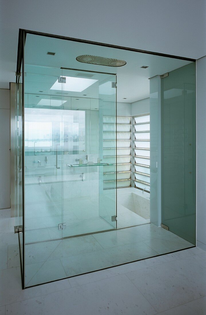 Bathroom with glass shower cubicle & sunken bathtub