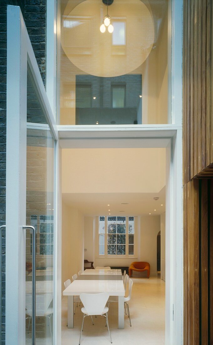 View through open glass door into dining room