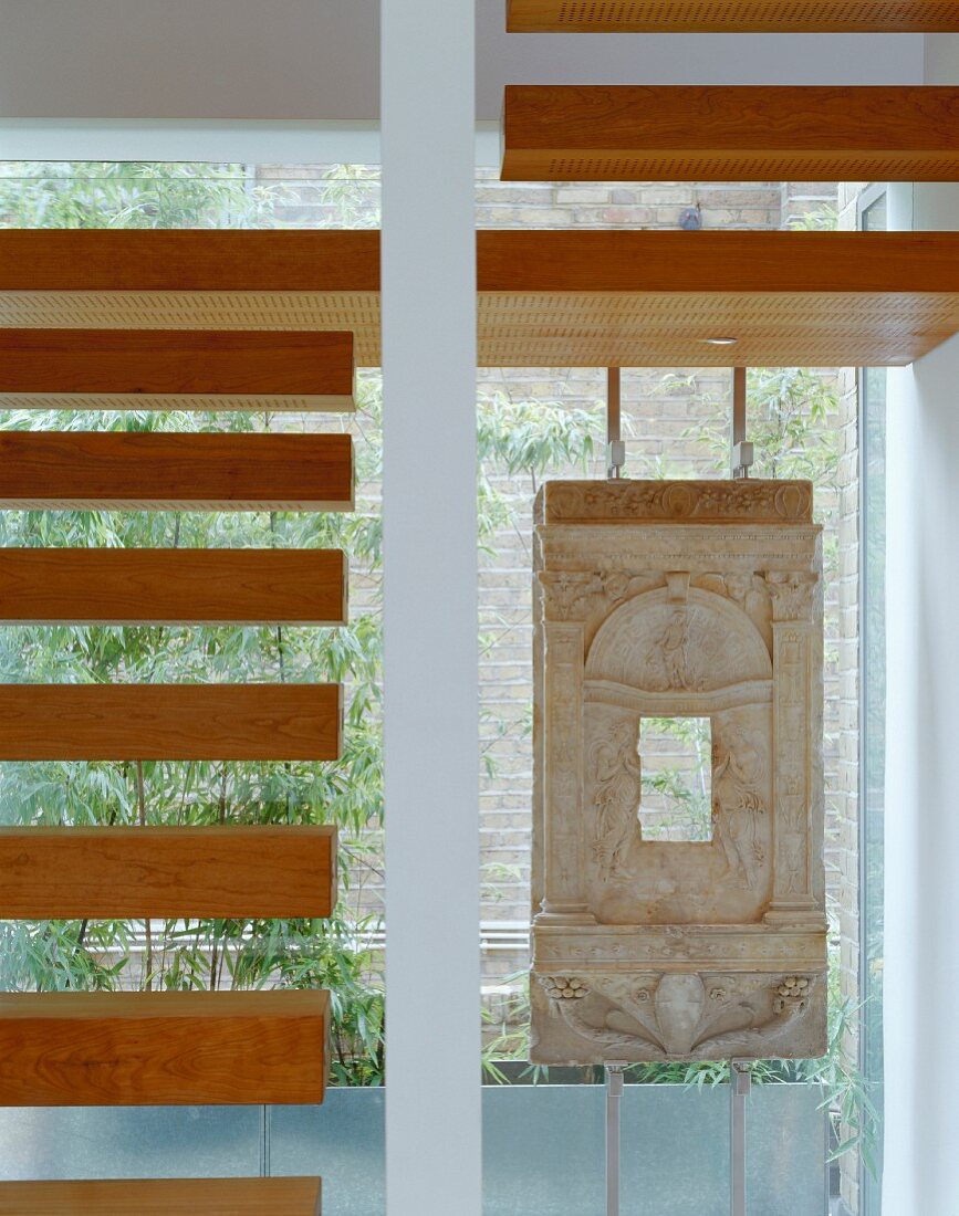Wooden stair treads in stairwell with window