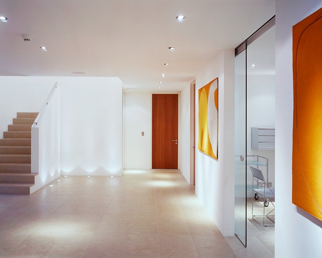 Grosszügiger moderner Vorraum mit Treppenaufgang und offenstehender Glasschiebetür