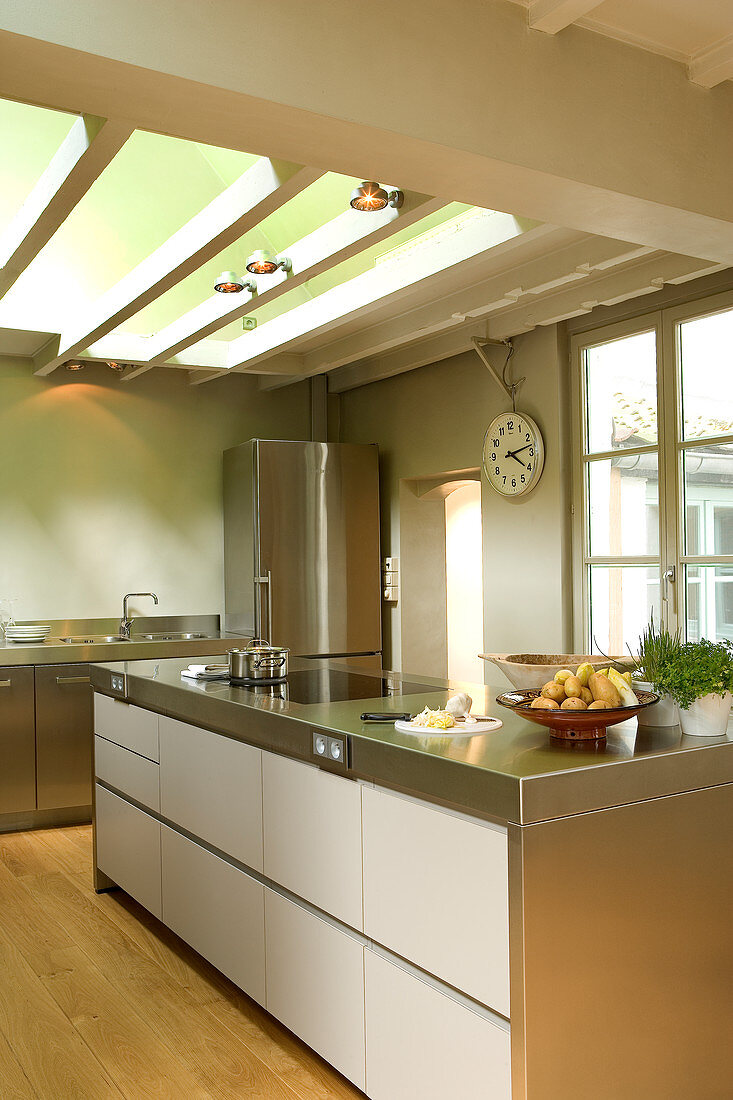 Kitchen counter with stainless steel worksurface in designer kitchen with traditional atmosphere