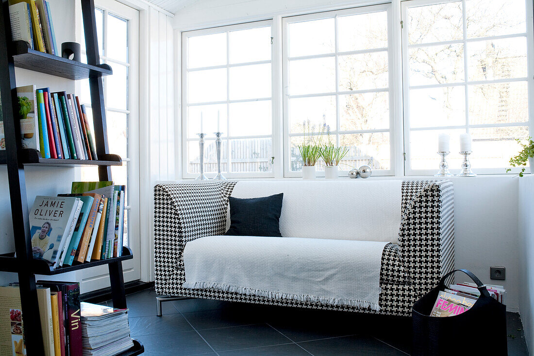 Living room with black and white sofa and bookshelf