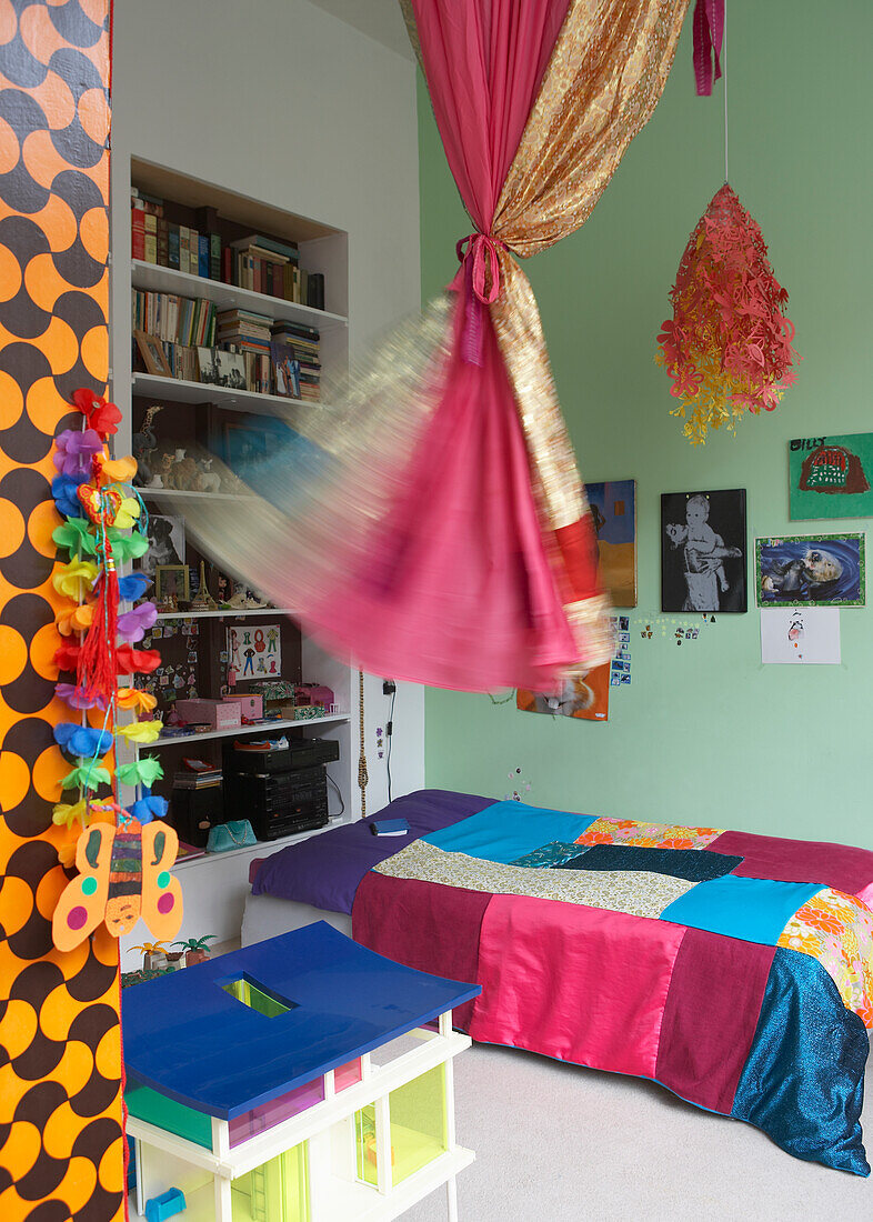 Colourful children's room with patchwork quilt and decorations