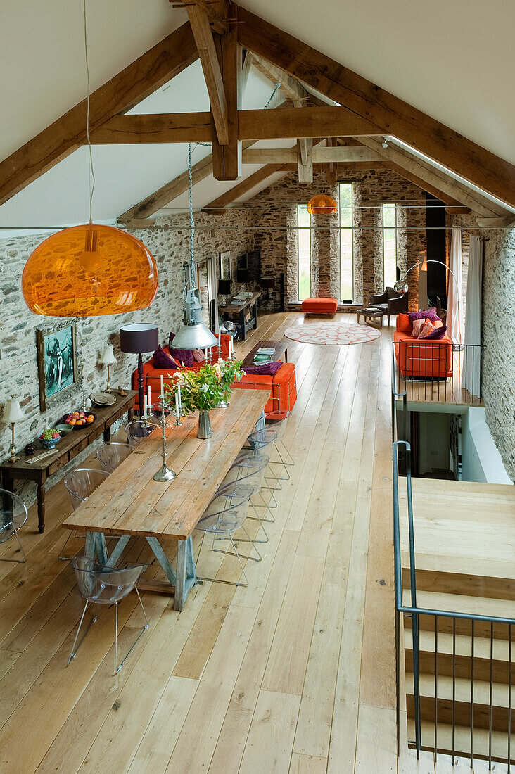 Rustic loft-style dining area with stone walls and wooden beams