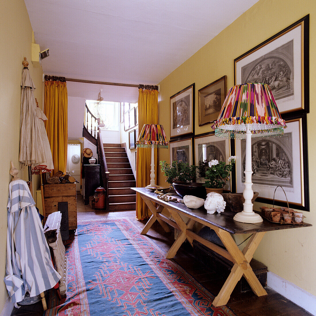 Hallway with color pattern carpet, wooden table and vintage lampshades