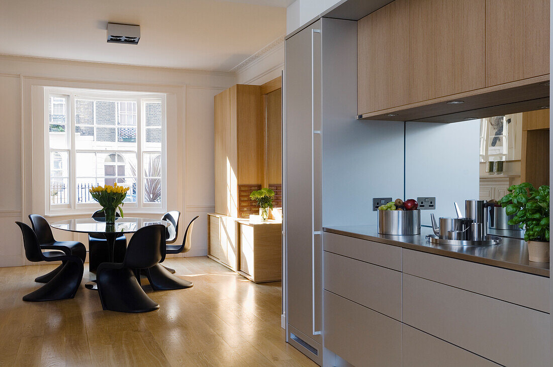 Kitchen with wooden accents and dining table with black chairs