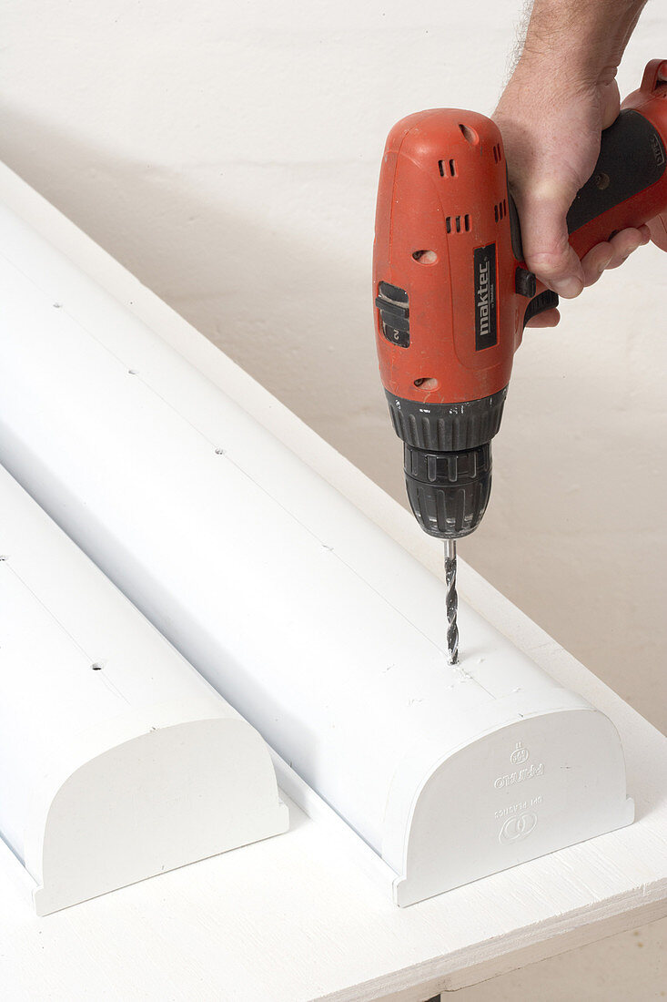 Drilling holes in white plastic container