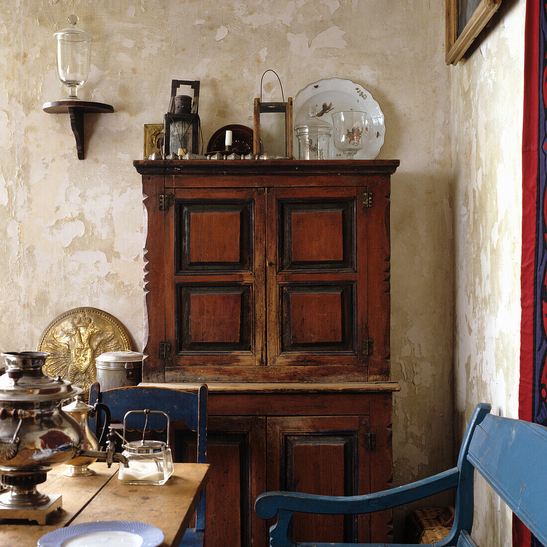 Antique wooden cabinet and wooden table in rustic dining room