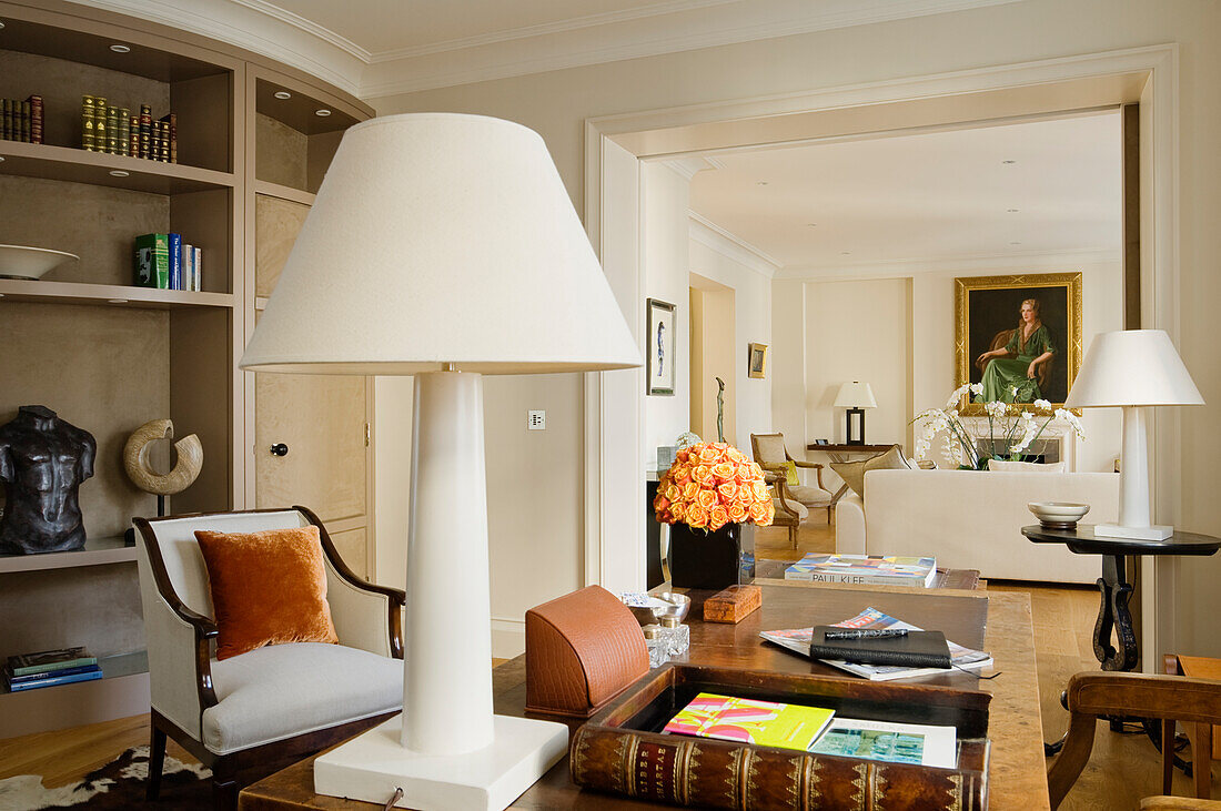 Living room with shelves, flowers, paintings and sculptures