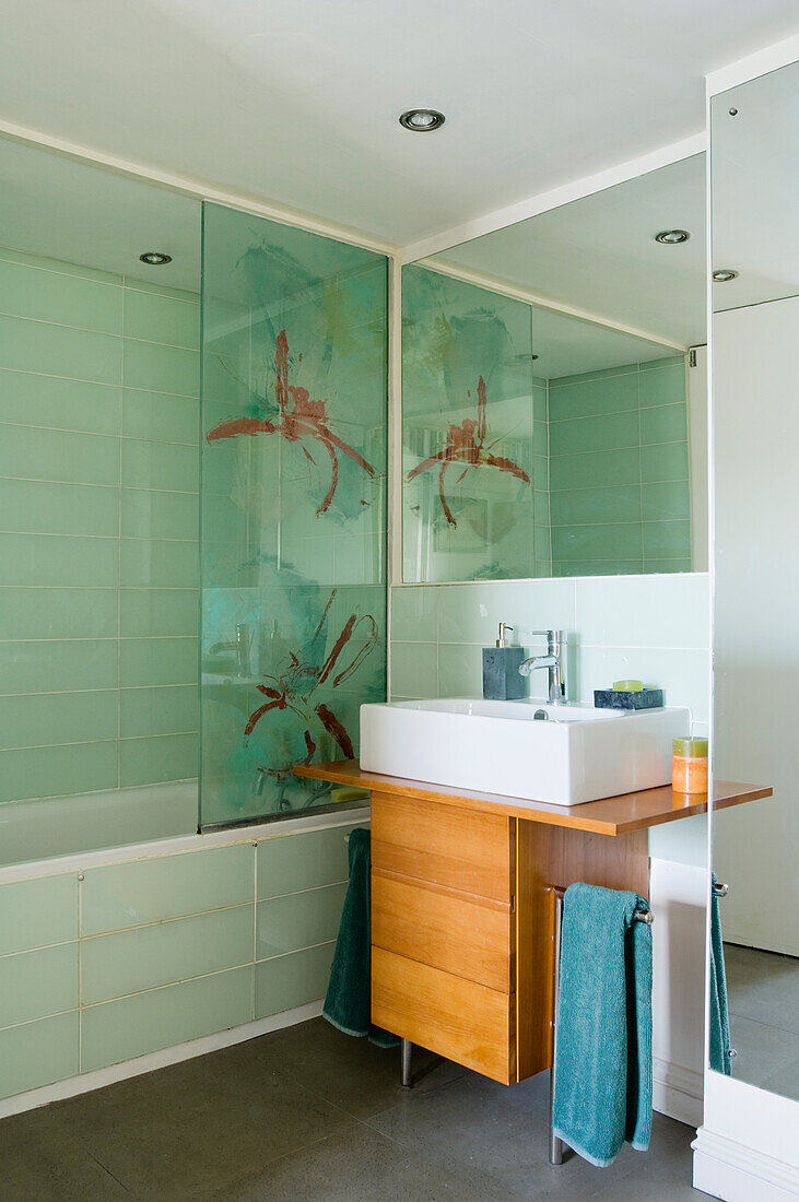 Bathroom with washbasin and wooden vanity unit, shower screen with print