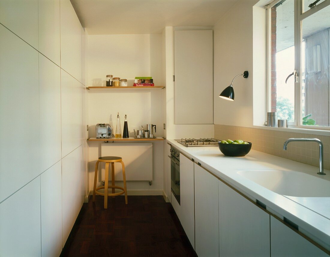 White kitchen with shelves & stool
