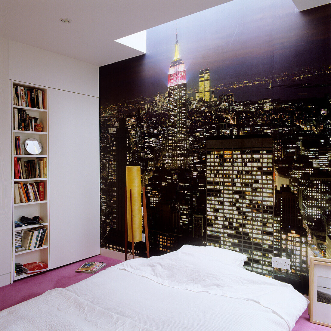 Bedroom with New York City wallpaper and white bed linen