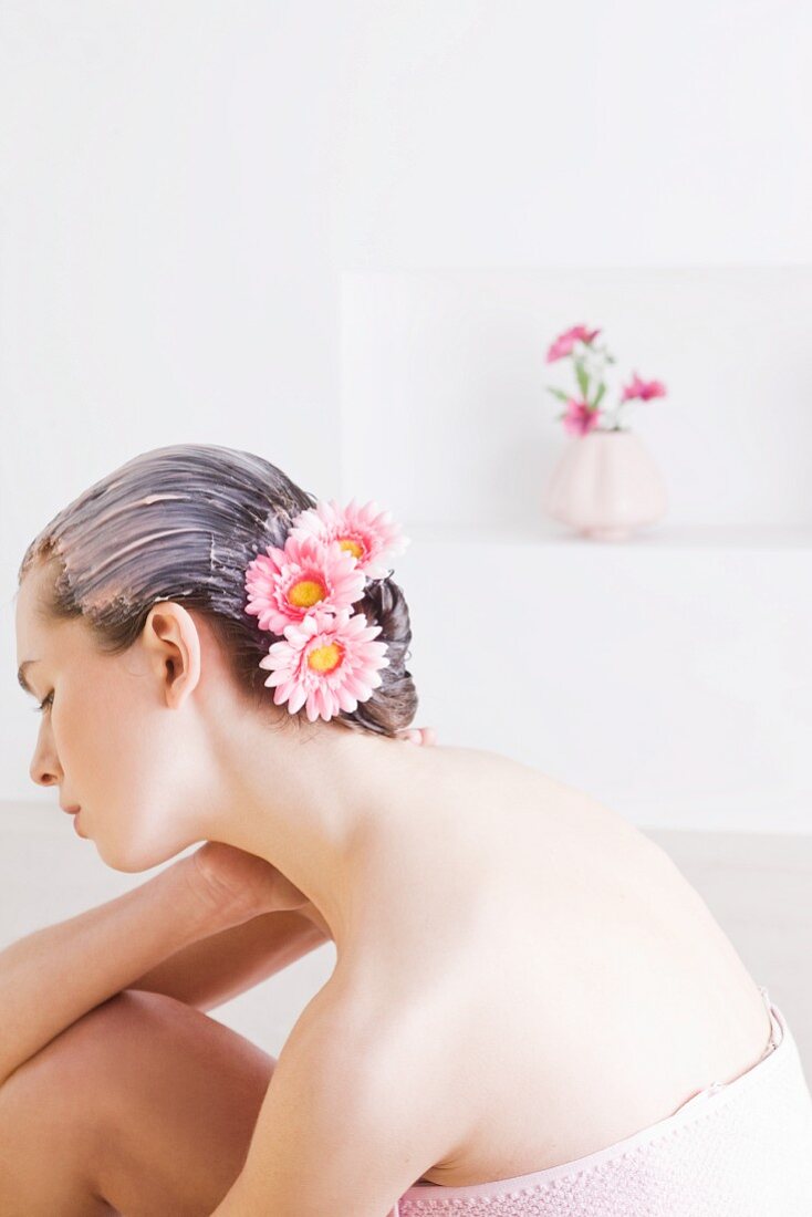 Young woman with floral hair treatment