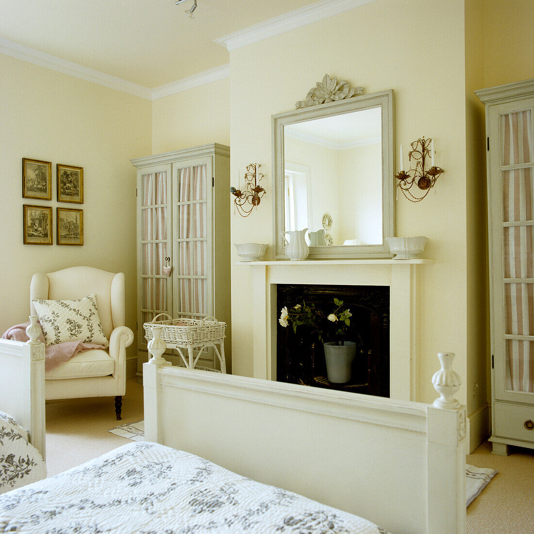 Bright bedroom with fireplace, mirror and floral accents