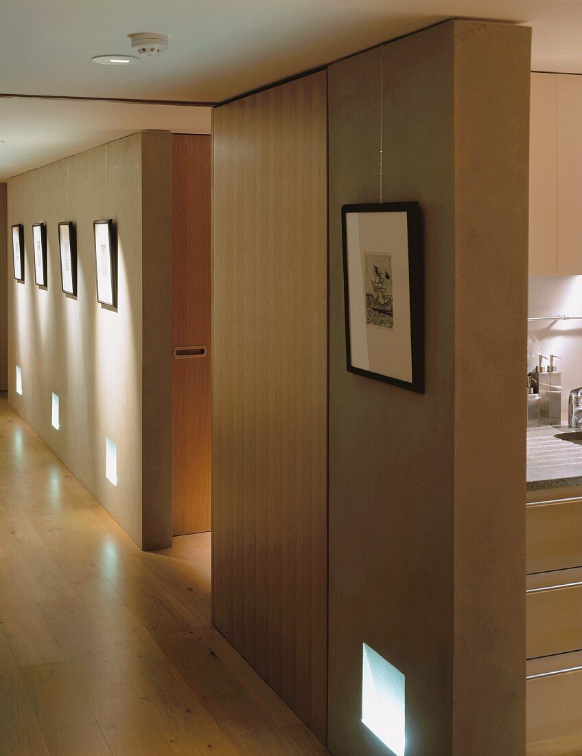 A long corridor hung with pictures and a view into the kitchen