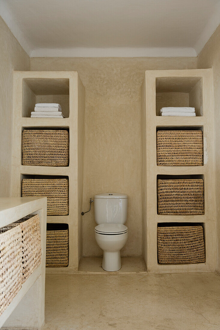 Bathroom with built-in shelves and toilet