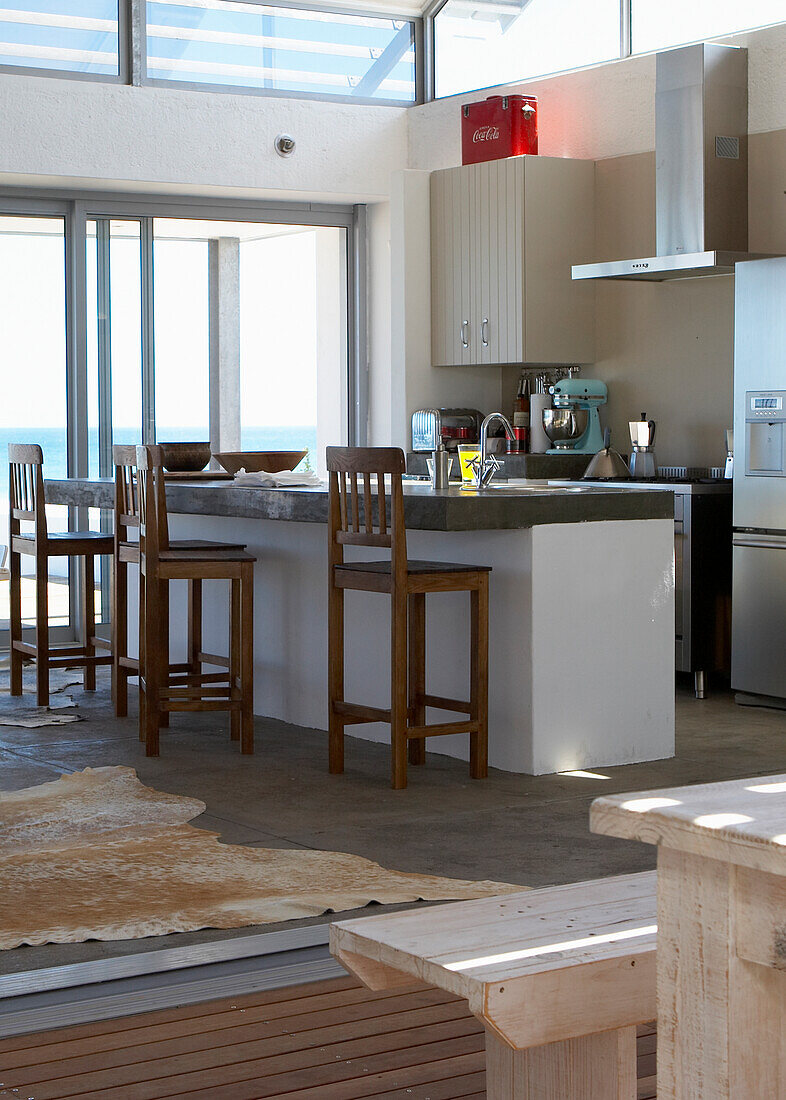 Kitchen unit with bar stools and sea view in modern holiday home