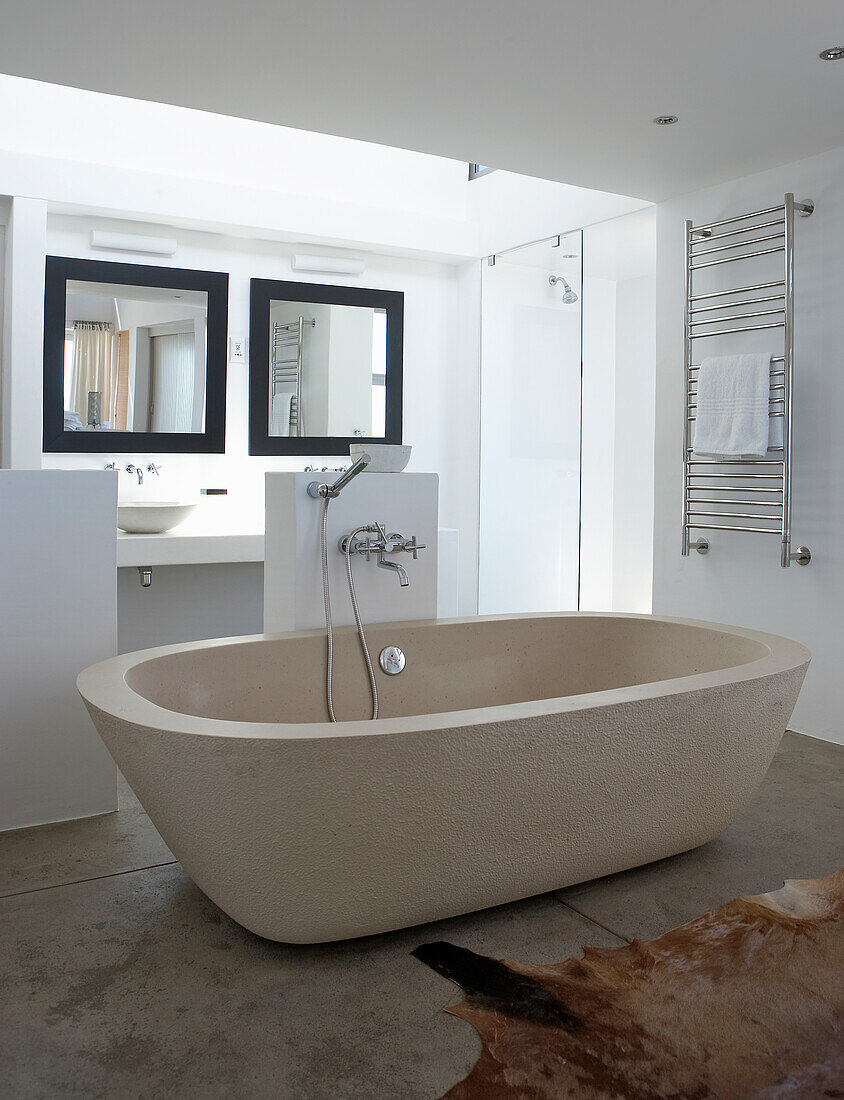 Freestanding bathtub in bright bathroom with modern design