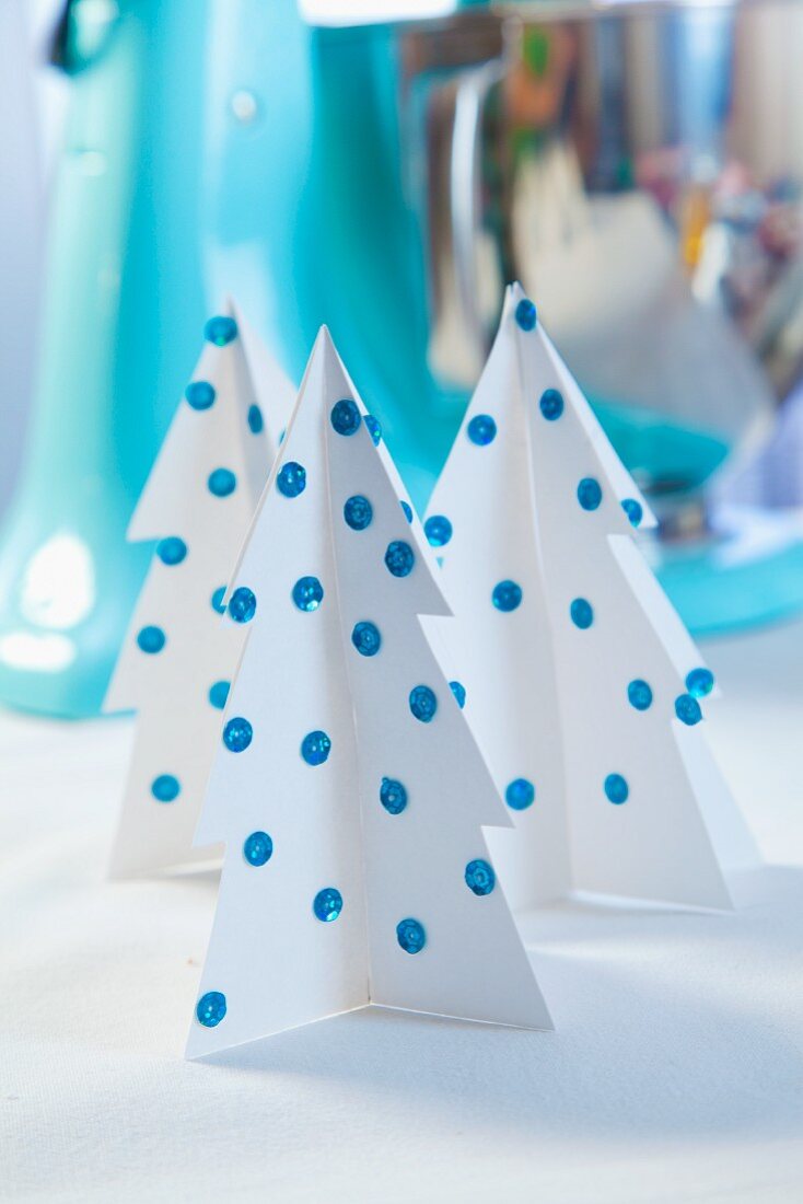 Paper Christmas trees decorated with sequins as Christmas decorations