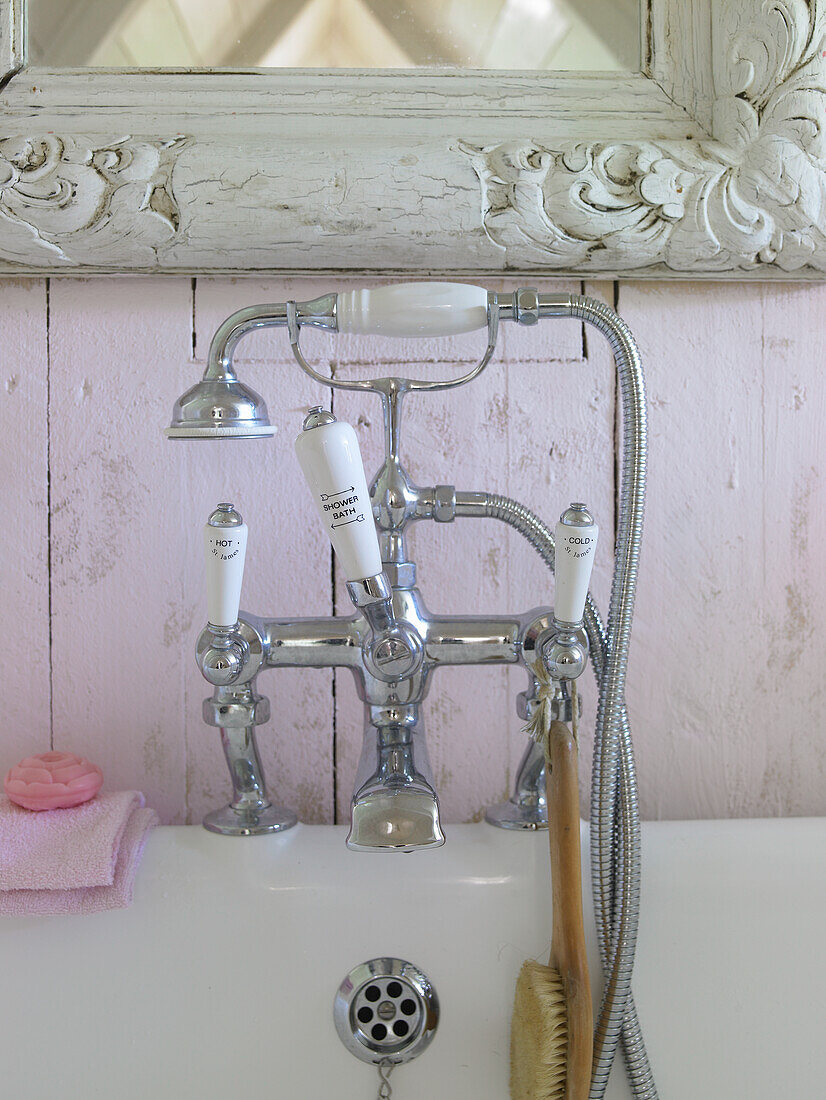 Ornate retro fitting with shower head over a bathtub