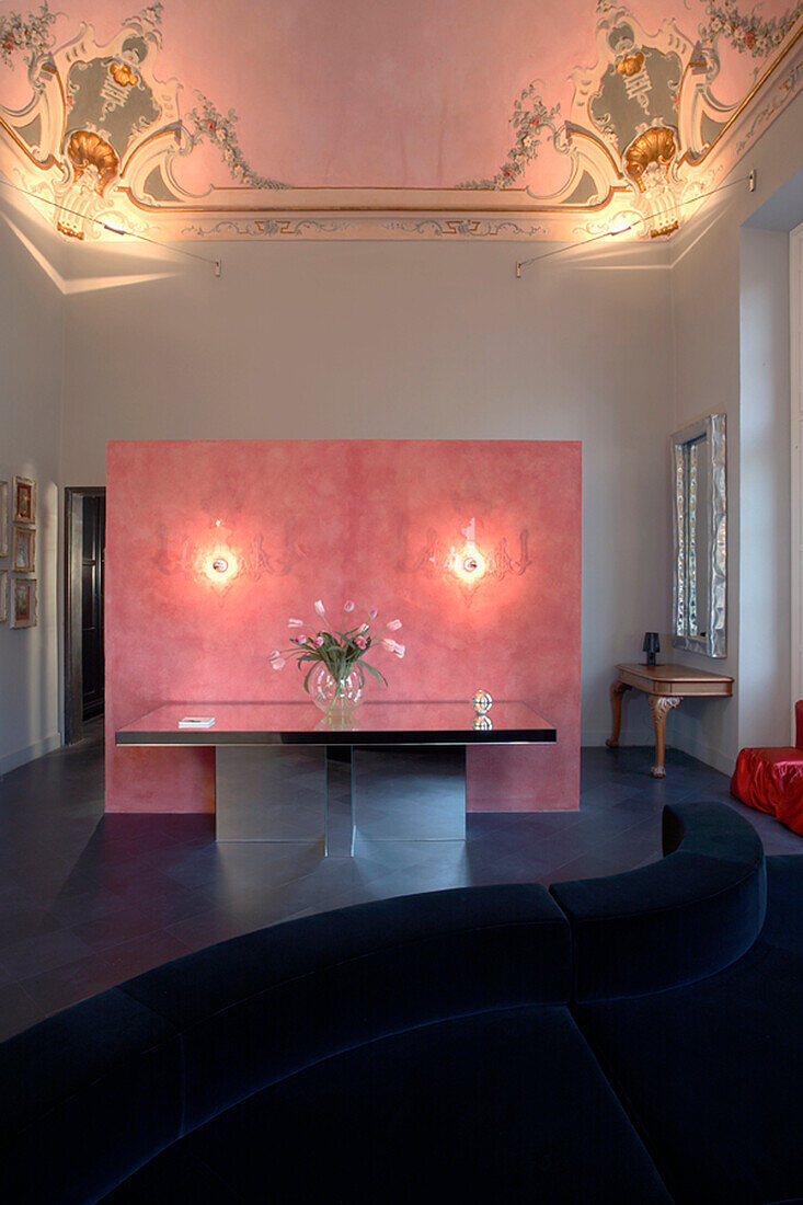 Pink room divider partition and flower vase on table in historic room