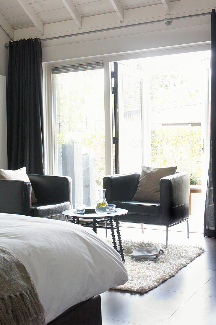 Room with patio door, dark furniture and fluffy carpet