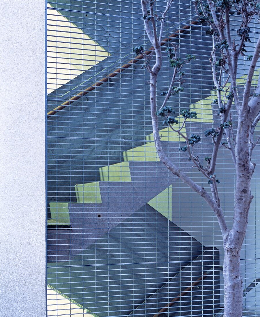 View of exterior staircase through metal grid