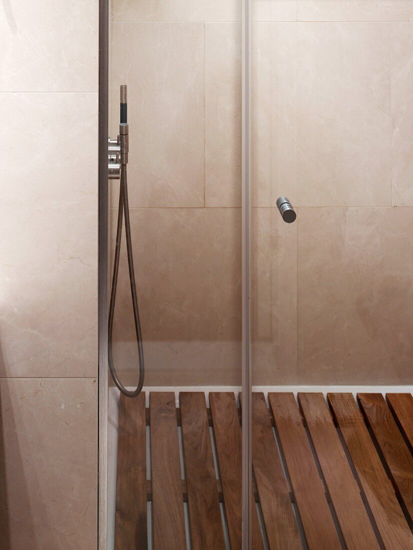 Tiled shower area with wooden slatted floor