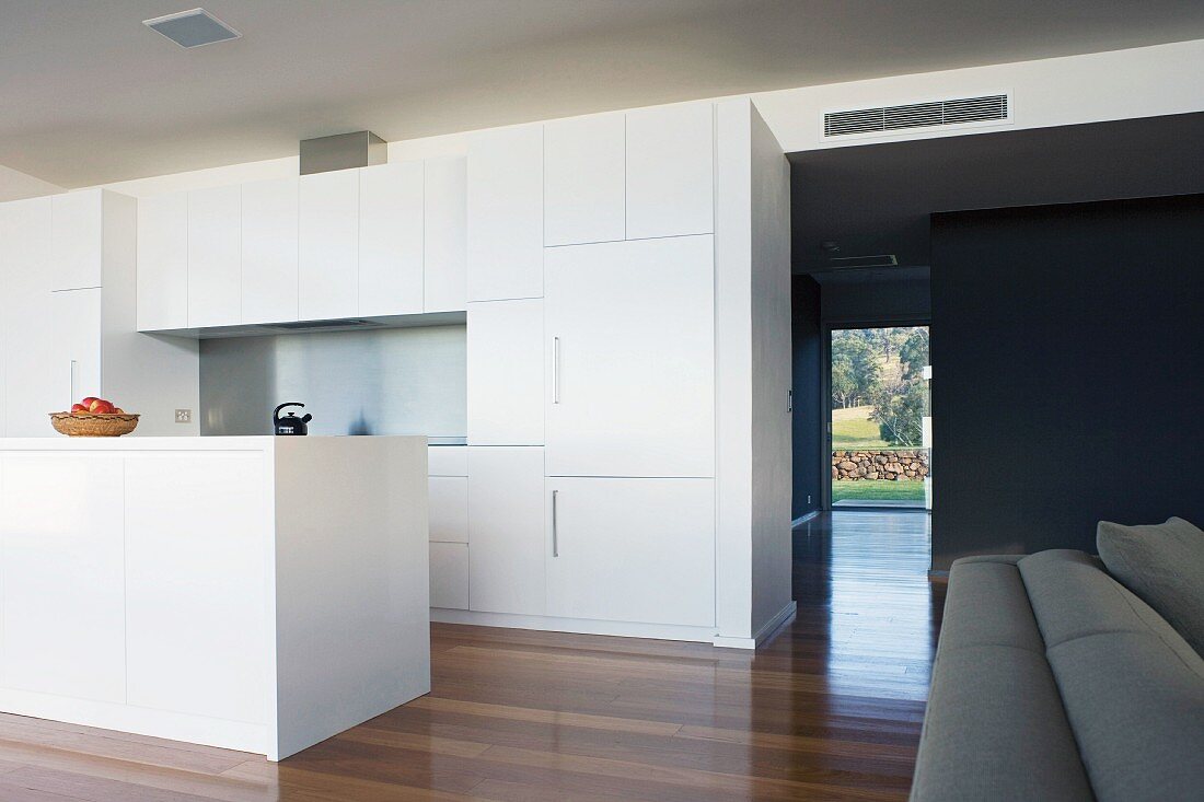 Open-plan white kitchen with island