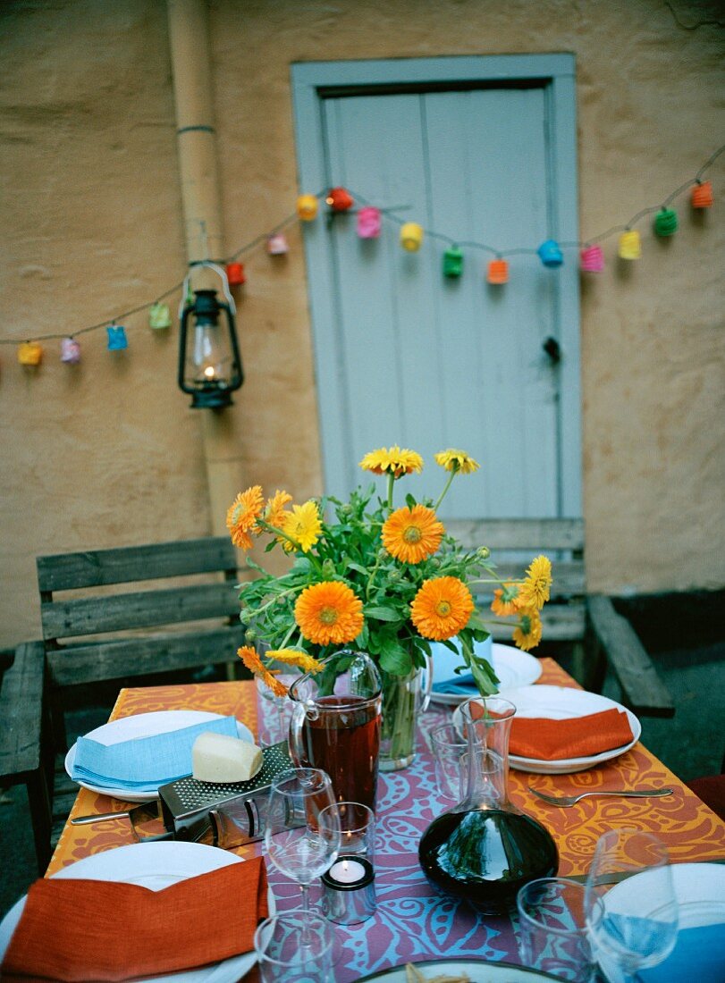 Bouquet of pot marigolds on set table outdoors