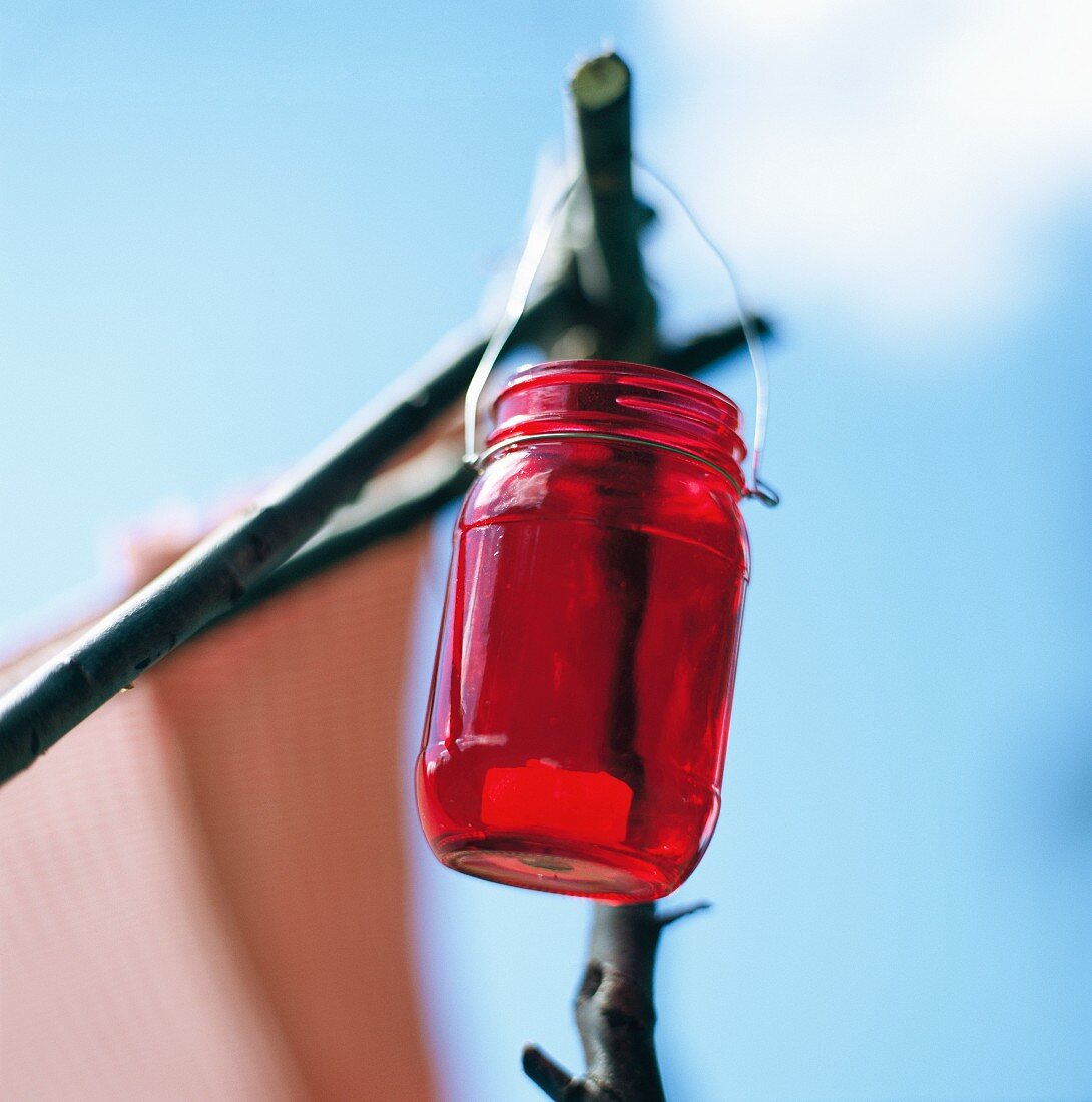 Lantern made from a red jam jar