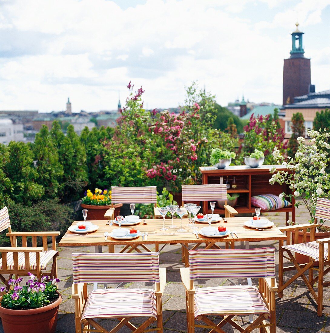 Set table on roof terrace with view across Stockholm