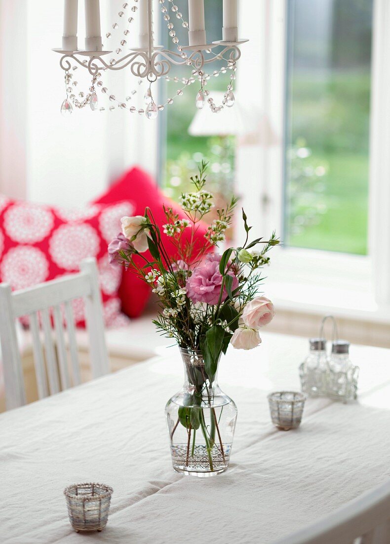 Flowers in glass vase on table