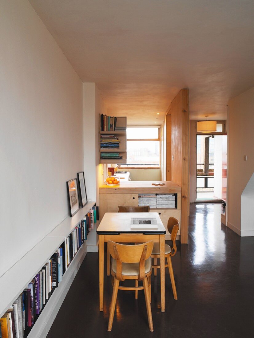 Dining area with serving hatch to kitchen and bookshelf