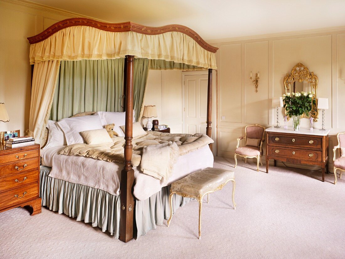 Antique four-poster bed with canopy in traditional bedroom