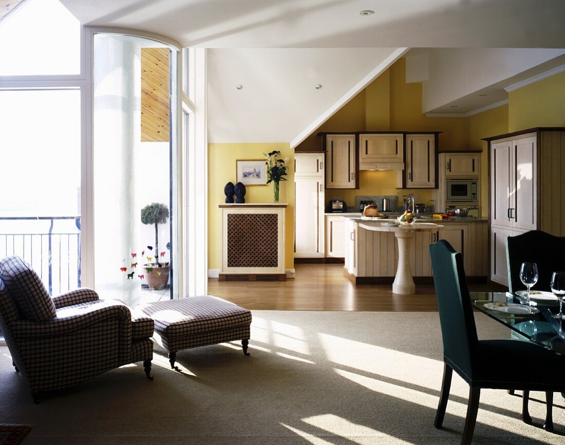 Open-plan living-dining room flooded with sunlight from adjacent terrace