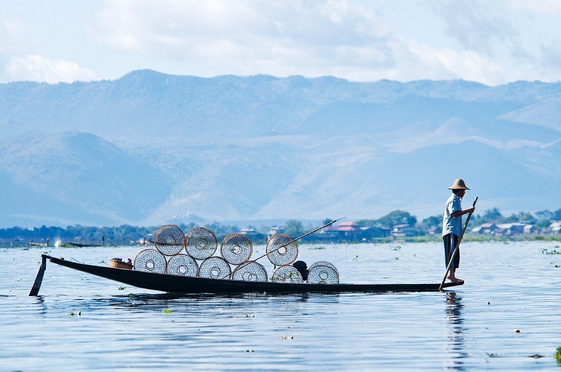 A man on a rowing boat on Inle Lake in Mayanmar (Burma)