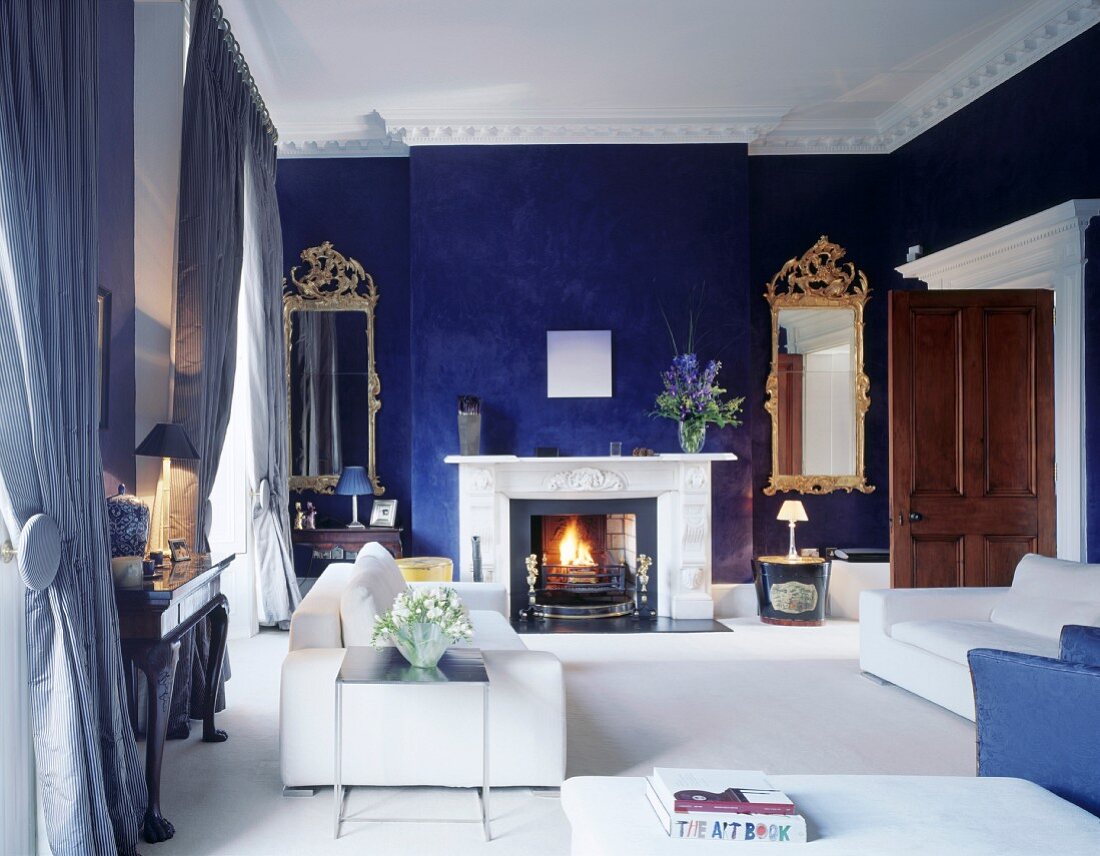 Modern living room furnishings and blue-painted walls in traditional setting