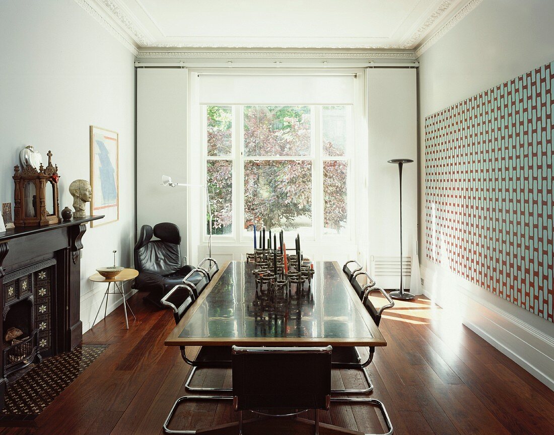 Modern dining table with cantilever chairs in front of sash window