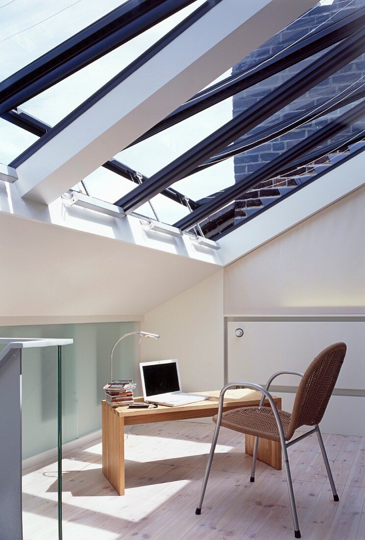 Modern home office below slanting glass roof