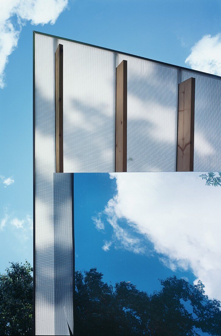 View of roof overhang on contemporary house with mirrored facade