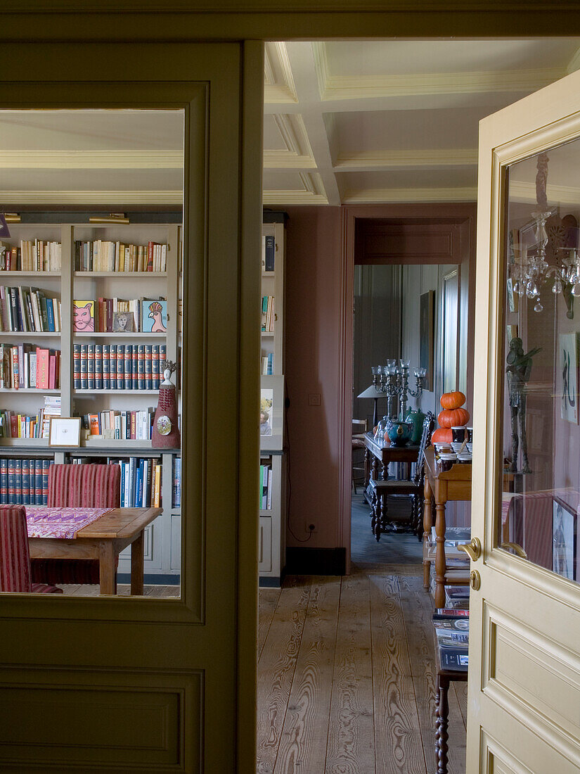 Room with bookshelf and dining table with chairs