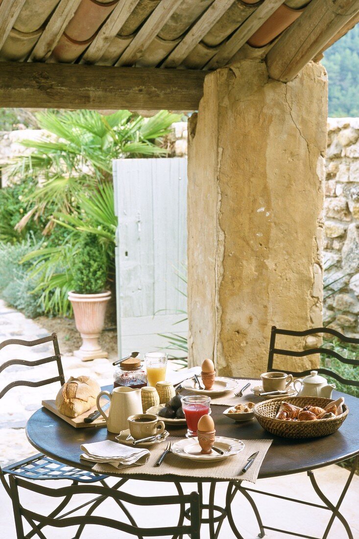 Breakfast table on roofed terrace