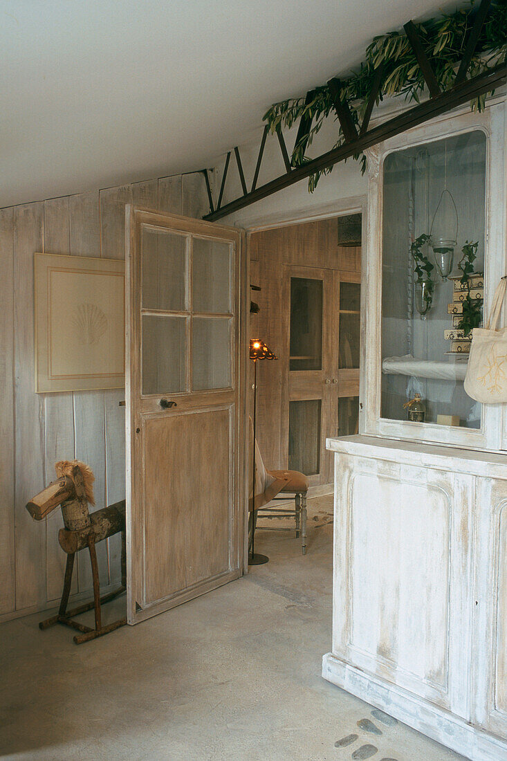 Country-style entrance area with display cabinet and wooden details