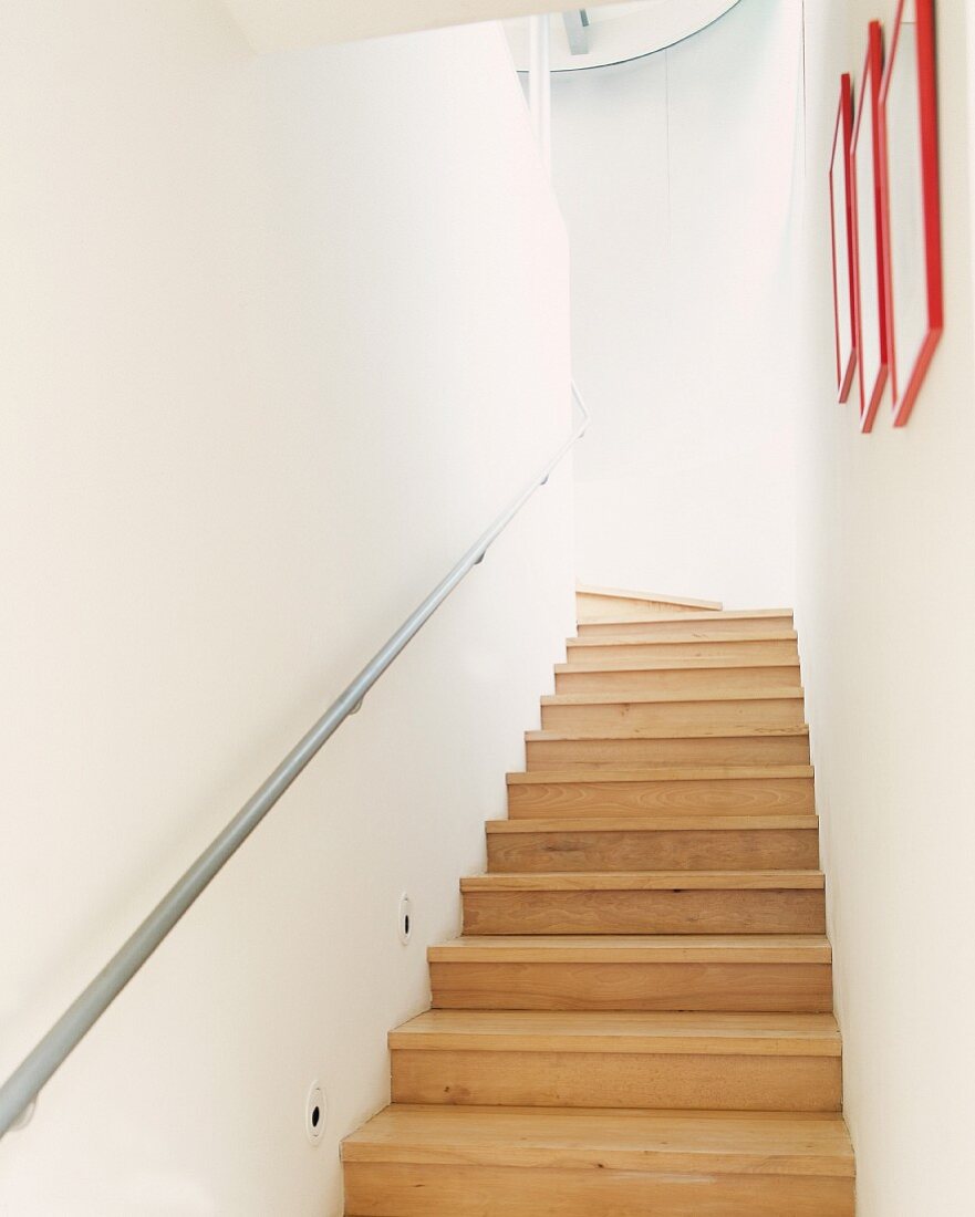 Narrow, modern staircase with wooden stairs