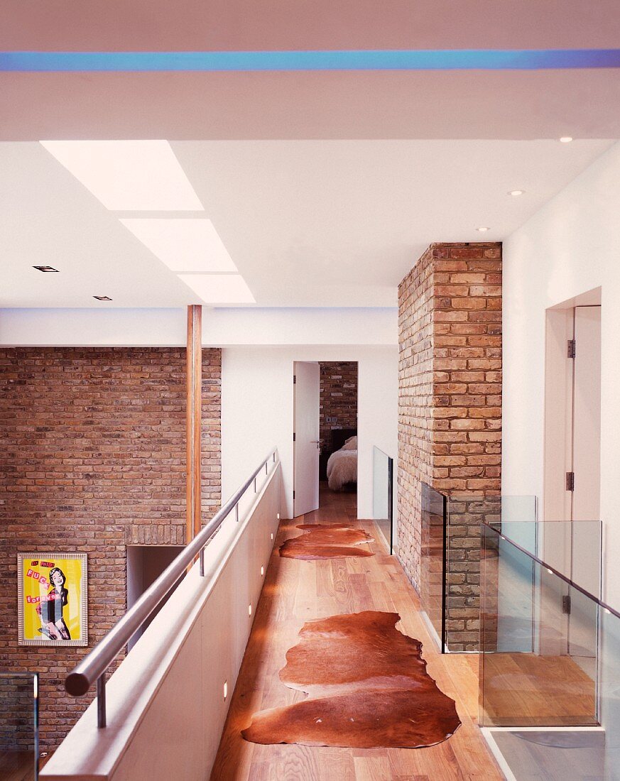 Gallery in contemporary house with brick walls