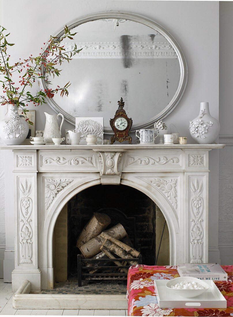 Open fireplace with ornamental surround & mirror above