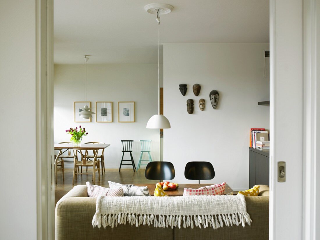 Light, retro designer chairs in modern, open-plan living-dining room