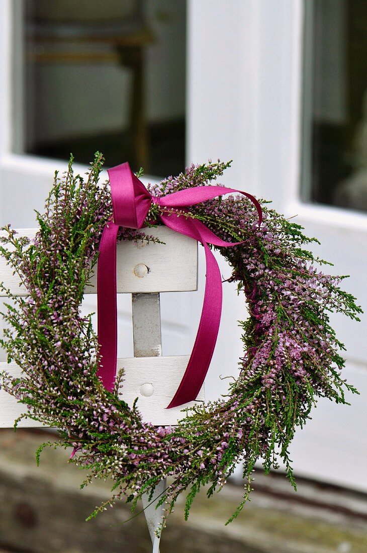 Heather wreath with purple ribbon