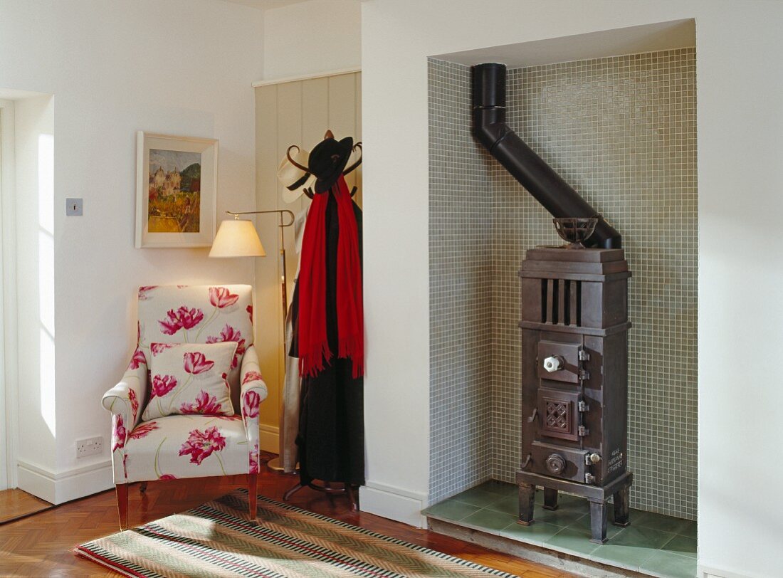 Foyer with old coal-fired stove, armchair & coat rack